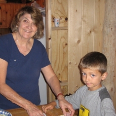 Vera cooking with her grandson Marco up at the cabin