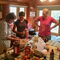 Vera giving cooking lessons to an eager family audience