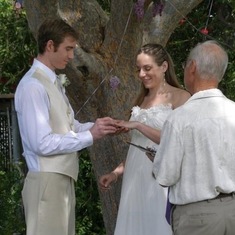Both weddings held in their backyard under the “love tree”