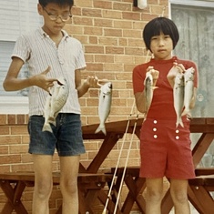 1970. Nine-year old Vivian and older brother Buck show off their catch of bluefish and crappie
