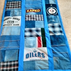 Lorraine made blankets for their three kids out of Walters denim jeans even the pockets, tees, team logo tees, and plaid shirts. Making them was a form of therapy.