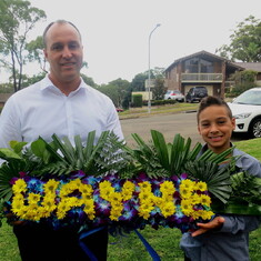 Brother Nigel with son Jordan holding floral tribute designed by sister Gail for Sydney Memorial Service