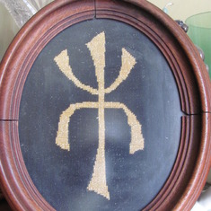 Insignia developed by Wesley for his jewelry.  Symbol cross-stitched by Ellen.