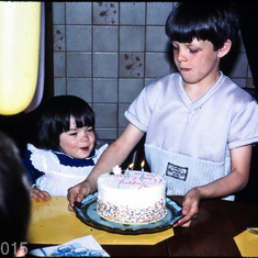Bringing his sister's Birthday cake, 1984