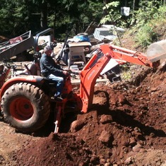 Dad on Tractor using backhoe at Brock and Diana's house in White Salmon, WA.
