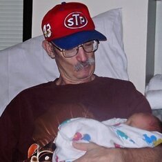 Wander what he was thinking as this would be his first and last time holding his only grandchild.