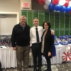 Papa & Mimi celebrating with Cavin at his Football Banquet.