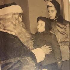 Dad and his brother David with Santa Claus