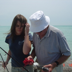 Shannon gets one of her many fishing lessons from Grandpa