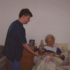Ryan giving Grandma breakfast in bed at his house