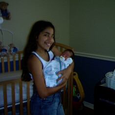 Gigi holding Justin her cousin for the first time