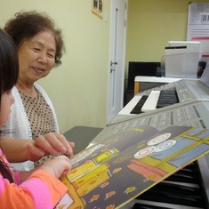 Doing piano lessons with her grand-daughter