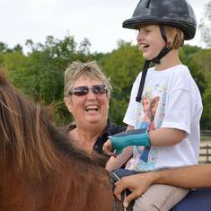 Zoe smiling on her horse - Spirit Riding Free