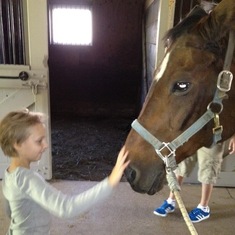Petting her beloved horses