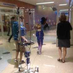 Ethan and Zoe walking through the hall with her IV pole. Zoe hated it and called it “Mary Schmutz”